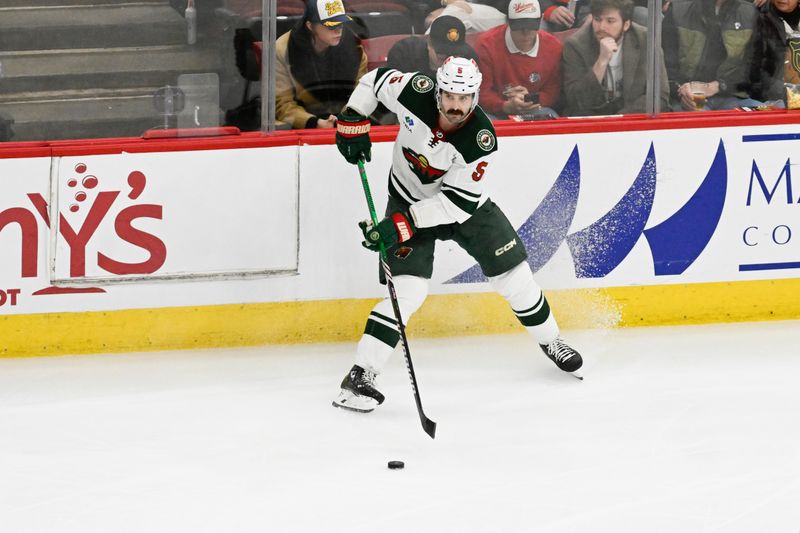 Apr 7, 2024; Chicago, Illinois, USA;  Minnesota Wild defenseman Jake Middleton (5) moves the puck against the Chicago Blackhawks during the third period at United Center. Mandatory Credit: Matt Marton-USA TODAY Sports