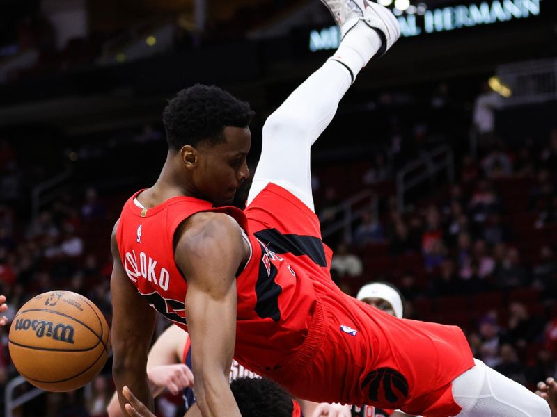 HOUSTON, TEXAS - FEBRUARY 03: Christian Koloko #35 of the Toronto Raptors collides with Jae'Sean Tate #8 of the Houston Rockets during the first half at Toyota Center on February 03, 2023 in Houston, Texas. NOTE TO USER: User expressly acknowledges and agrees that, by downloading and or using this photograph, User is consenting to the terms and conditions of the Getty Images License Agreement. (Photo by Carmen Mandato/Getty Images)