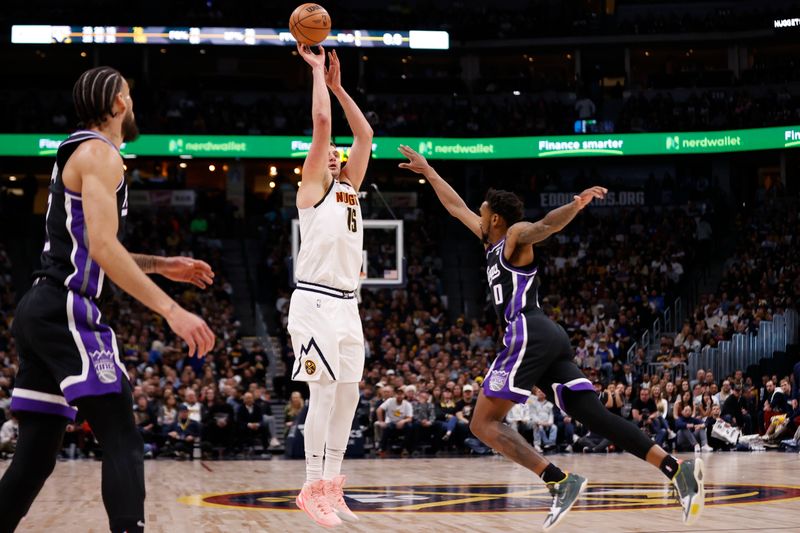 DENVER, COLORADO - FEBRUARY 28: Nikola Jokic #15 of the Denver Nuggets shoots against Malik Monk #0 of the Sacramento Kings during the game at Ball Arena on February 28, 2024 in Denver, Colorado. NOTE TO USER: User expressly acknowledges and agrees that, by downloading and or using this photograph, User is consenting to the terms and conditions of the Getty Images License Agreement. (Photo by Brendall O'Banon/Clarkson Creative/Getty Images)