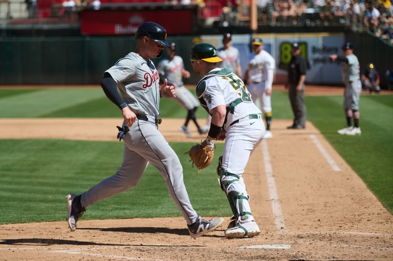 Sep 7, 2024; Oakland, California, USA; Detroit Tigers infielder Spencer Torkelson (20) scores a run against Oakland Athletics catcher Kyle McCann (52) during the seventh inning at Oakland-Alameda County Coliseum. Mandatory Credit: Robert Edwards-Imagn Images
