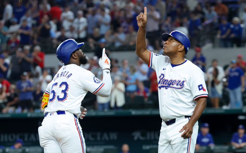Sep 18, 2024; Arlington, Texas, USA;  Texas Rangers right fielder Adolis Garcia (53) celebrates with Texas Rangers third base coach Tony Beasley (27) after hitting a two-run home run during the sixth inning against the Toronto Blue Jays at Globe Life Field. Mandatory Credit: Kevin Jairaj-Imagn Images