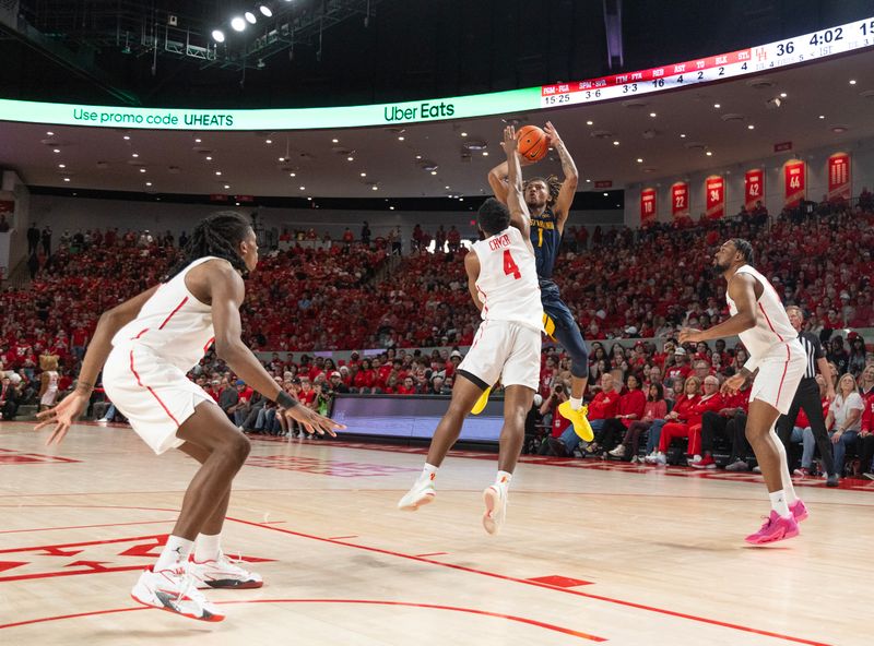 Jan 6, 2024; Houston, Texas, USA;West Virginia Mountaineers guard Noah Farrakhan (1) shoots against Houston Cougars guard L.J. Cryer (4) in the first half  at Fertitta Center. Mandatory Credit: Thomas Shea-USA TODAY Sports