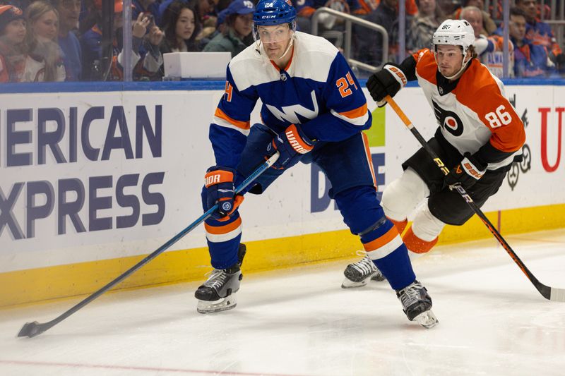 Nov 25, 2023; Elmont, New York, USA; New York Islanders defenseman Scott Mayfield (24) controls the puck while being pursued by Philadelphia Flyers left wing Joel Farabee (86) during the first period at UBS Arena. Mandatory Credit: Thomas Salus-USA TODAY Sports