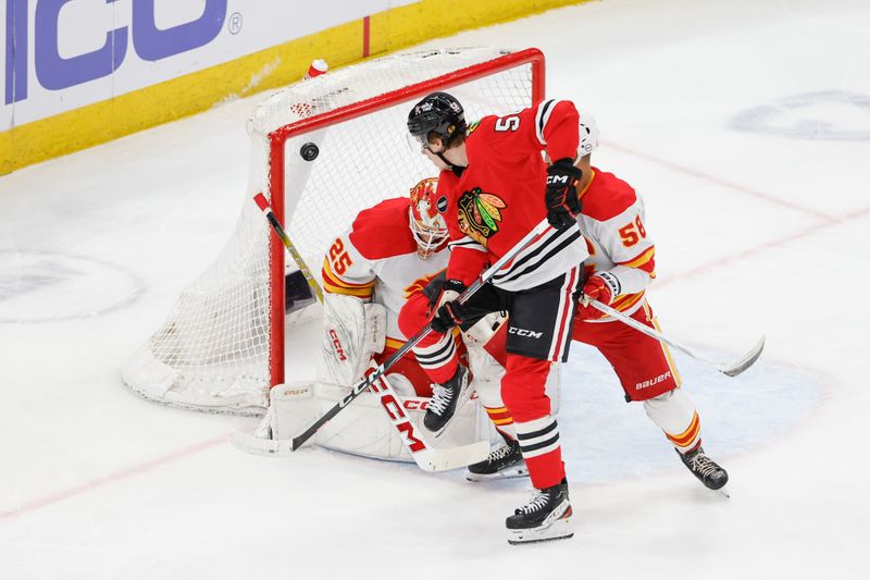 Mar 26, 2024; Chicago, Illinois, USA; Chicago Blackhawks right wing MacKenzie Entwistle (58) tries to score against Calgary Flames goaltender Jacob Markstrom (25) during the first period at United Center. Mandatory Credit: Kamil Krzaczynski-USA TODAY Sports