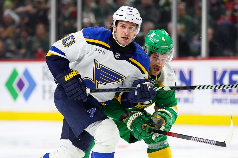 Mar 23, 2024; Saint Paul, Minnesota, USA; St. Louis Blues left wing Brandon Saad (20) and Minnesota Wild defenseman Jon Merrill (4) compete for the puck during the second period at Xcel Energy Center. Mandatory Credit: Matt Krohn-USA TODAY Sports