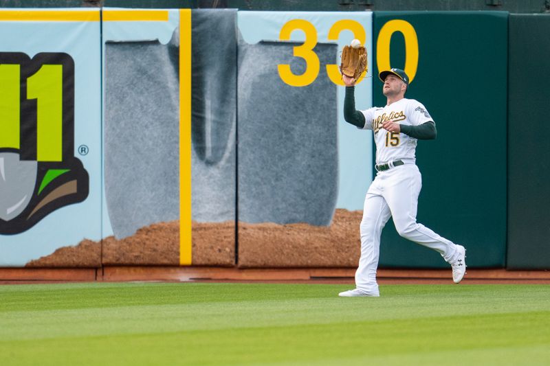 Jun 13, 2023; Oakland, California, USA; Oakland Athletics left fielder Seth Brown (15) fields a fly ball against the Tampa Bay Rays during the fourth inning at Oakland-Alameda County Coliseum. Mandatory Credit: Neville E. Guard-USA TODAY Sports