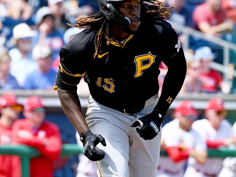 Mar 18, 2024; Clearwater, Florida, USA; Pittsburgh Pirates shortstop Oniel Cruz (15) drives in a run in the second inning of the spring training game against the Philadelphia Phillies at BayCare Ballpark. Mandatory Credit: Jonathan Dyer-USA TODAY Sports