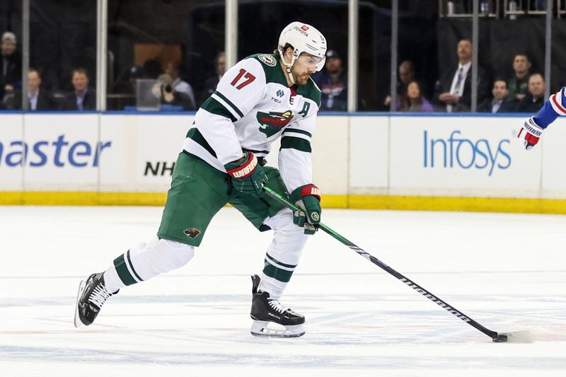 Apr 2, 2025; New York, New York, USA;  Minnesota Wild left wing Marcus Foligno (17) controls the puck in the first period against the New York Rangers at Madison Square Garden. Mandatory Credit: Wendell Cruz-Imagn Images