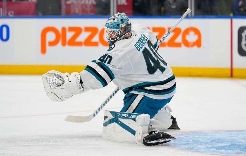 Mar 3, 2025; Toronto, Ontario, CAN; San Jose Sharks goaltender Alexandar Georgiev (40) goes to make a save during warm up before a game against the Toronto Maple Leafs at Scotiabank Arena. Mandatory Credit: John E. Sokolowski-Imagn Images