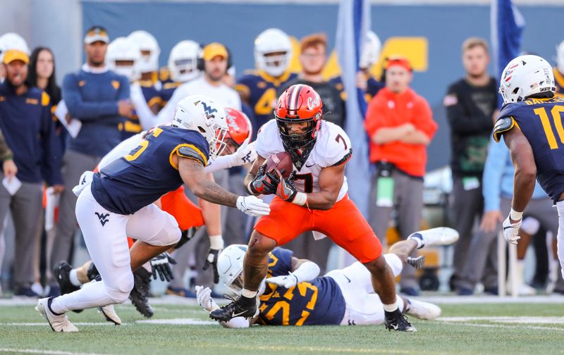 Nov 6, 2021; Morgantown, West Virginia, USA; Oklahoma State Cowboys running back Jaylen Warren (7) catches a pass and runs for extra yards during the second quarter against the West Virginia Mountaineers at Mountaineer Field at Milan Puskar Stadium. Mandatory Credit: Ben Queen-USA TODAY Sports