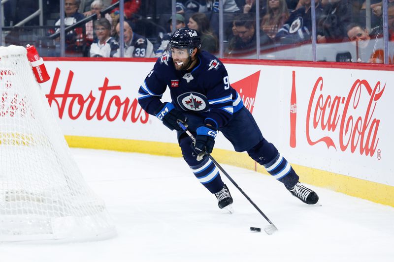 Nov 5, 2024; Winnipeg, Manitoba, CAN;  Winnipeg Jets forward Alex Iafallo (9) looks to make a pass behind the Utah net during the second period at Canada Life Centre. Mandatory Credit: Terrence Lee-Imagn Images