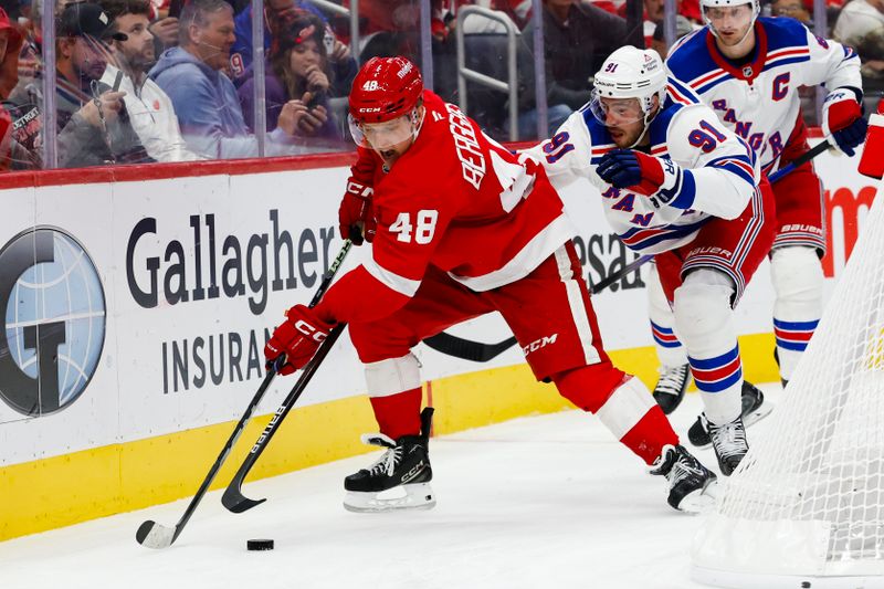 Oct 17, 2024; Detroit, Michigan, USA;  Detroit Red Wings right wing Jonatan Berggren (48) skates with the puck defended by New York Rangers right wing Reilly Smith (91) in the second period at Little Caesars Arena. Mandatory Credit: Rick Osentoski-Imagn Images