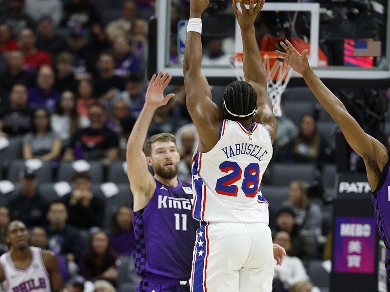 SACRAMENTO, CALIFORNIA - JANUARY 01: Guerschon Yabusele #28 of the Philadelphia 76ers shoots over Domantas Sabonis #11 of the Sacramento Kings during the first half of an NBA basketball game at Golden 1 Center on January 01, 2025 in Sacramento, California. NOTE TO USER: User expressly acknowledges and agrees that, by downloading and or using this photograph, User is consenting to the terms and conditions of the Getty Images License Agreement. (Photo by Thearon W. Henderson/Getty Images)