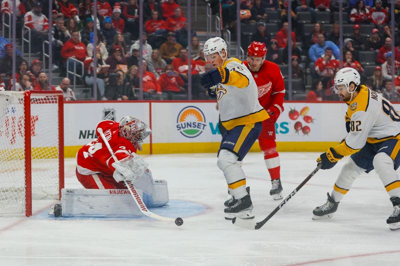 Dec 29, 2023; Detroit, Michigan, USA; Detroit Red Wings goaltender Matt Lyon (34) blocks a shot by Nashville Predators center Tommy Novak (82) during the first of the game between the Nashville Predators and the Detroit Red Wings at Little Caesars Arena. Mandatory Credit: Brian Bradshaw Sevald-USA TODAY Sports