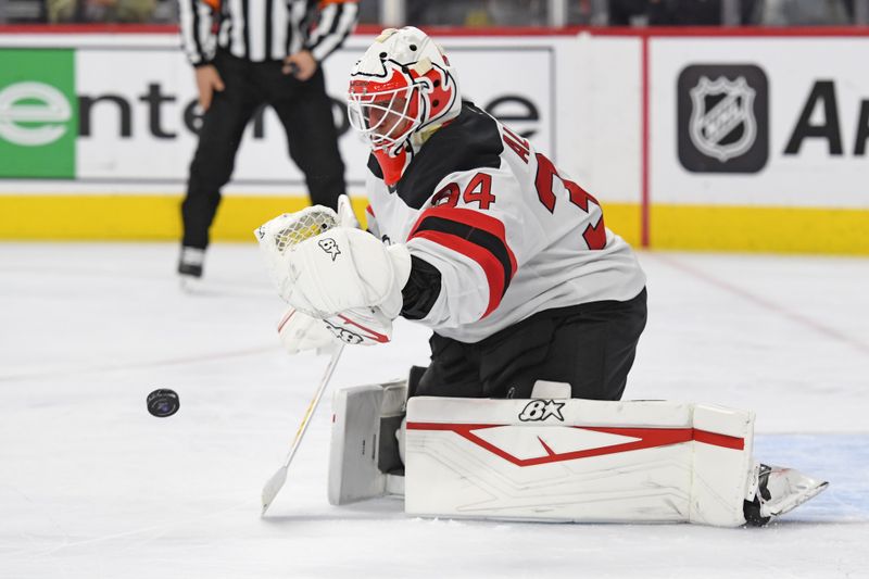 Jan 27, 2025; Philadelphia, Pennsylvania, USA; New Jersey Devils goaltender Jake Allen (34) makes a save against the Philadelphia Flyers during the first period at Wells Fargo Center. Mandatory Credit: Eric Hartline-Imagn Images