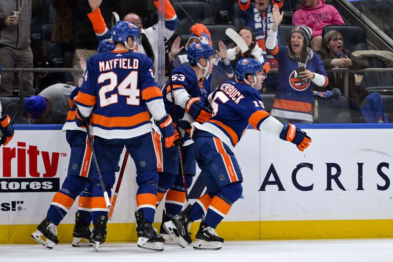 Dec 7, 2023; Elmont, New York, USA; New York Islanders right wing Cal Clutterbuck (15) celebrates with teammates after scoring a goal against the Columbus Blue Jackets during the second period at UBS Arena. Mandatory Credit: John Jones-USA TODAY Sports