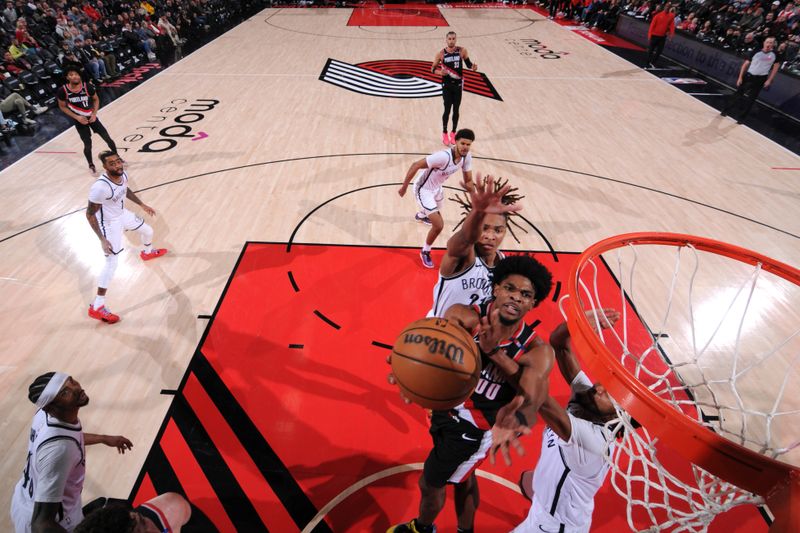 PORTLAND, OR - JANUARY 14: Scoot Henderson #00 of the Portland Trail Blazers drives to the basket during the game against the Brooklyn Nets on January 14, 2025 at the Moda Center Arena in Portland, Oregon. NOTE TO USER: User expressly acknowledges and agrees that, by downloading and or using this photograph, user is consenting to the terms and conditions of the Getty Images License Agreement. Mandatory Copyright Notice: Copyright 2025 NBAE (Photo by Cameron Browne/NBAE via Getty Images)