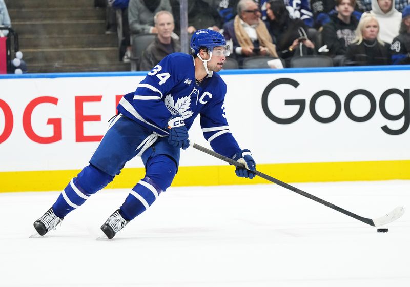 Oct 12, 2024; Toronto, Ontario, CAN; Toronto Maple Leafs center Auston Matthews (34) skates with the puck against the Pittsburgh Penguins during the second period at Scotiabank Arena. Mandatory Credit: Nick Turchiaro-Imagn Images