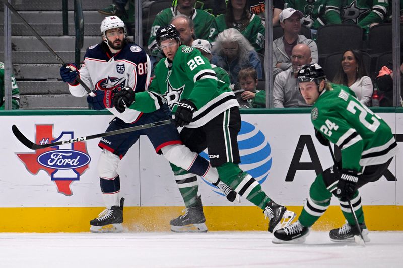 Oct 21, 2025; Dallas, Texas, USA; Dallas Stars defenseman Alexander Petrovic (28) checks Columbus Blue Jackets right wing Kirill Marchenko (86) during the second period at the American Airlines Center. Mandatory Credit: Jerome Miron-Imagn Images