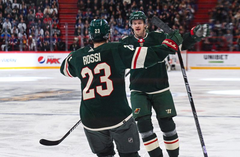 Nov 19, 2023; Stockholm, SWE; Minnesota Wild defenseman Jon Merrill (4) celebrates with Minnesota Wild center Marco Rossi (23) after scoring a goal against the Toronto Maple Leafs during a Global Series NHL hockey game at Avicii Arena. Mandatory Credit: Per Haljestam-USA TODAY Sports