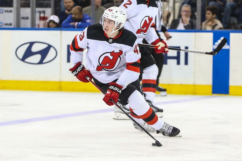 Apr 3, 2024; New York, New York, USA; New Jersey Devils defenseman Luke Hughes (43) controls the puck in the third period against the New York Rangers at Madison Square Garden. Mandatory Credit: Wendell Cruz-USA TODAY Sports