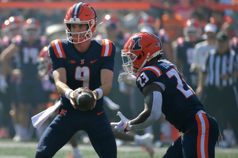 Sep 23, 2023; Champaign, Illinois, USA;  Illinois Fighting Illini quarterback Luke Altmyer (9) hands the ball to Illinois Fighting Illini running back Reggie Love III (23) during the fist half against the FL Atlantic Owls at Memorial Stadium. Mandatory Credit: Ron Johnson-USA TODAY Sports