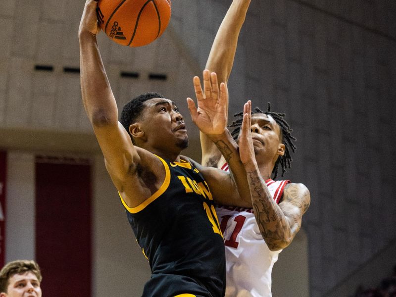 Feb 28, 2023; Bloomington, Indiana, USA; Iowa Hawkeyes guard Tony Perkins (11) shoots the ball while Indiana Hoosiers guard CJ Gunn (11) defends in the second half at Simon Skjodt Assembly Hall. Mandatory Credit: Trevor Ruszkowski-USA TODAY Sports