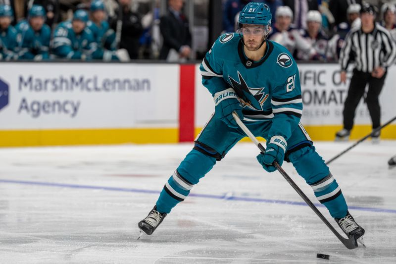 Nov 5, 2024; San Jose, California, USA;  San Jose Sharks center Alexander Wennberg (21) shoots the puck against the Columbus Blue Jackets during the second period at SAP Center at San Jose. Mandatory Credit: Neville E. Guard-Imagn Images