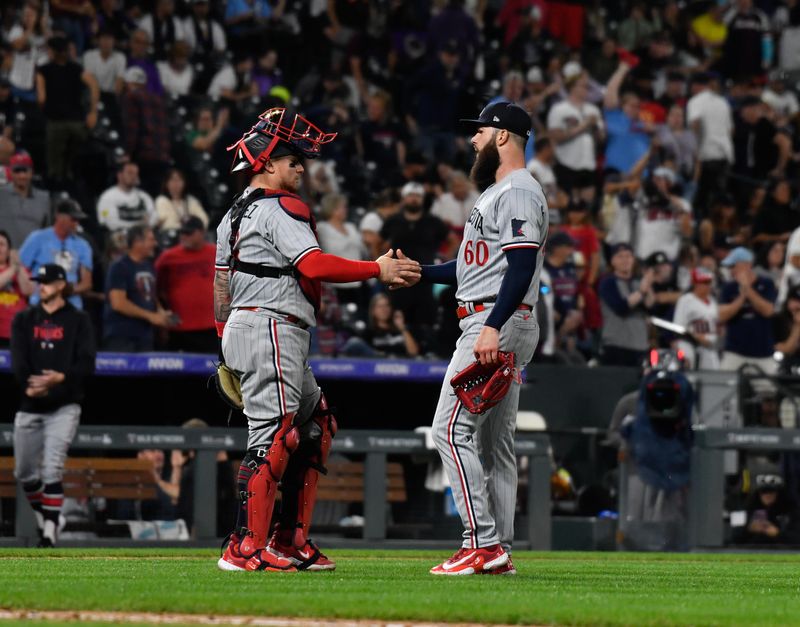 Sep 30, 2023; Denver, Colorado, USA; Minnesota Twins catcher Christian Vazquez (8) shakes hand with Minnesota Twins starting pitcher Dallas Keuchel (60) after the final out against the Minnesota Twins at Coors Field. Mandatory Credit: John Leyba-USA TODAY Sports