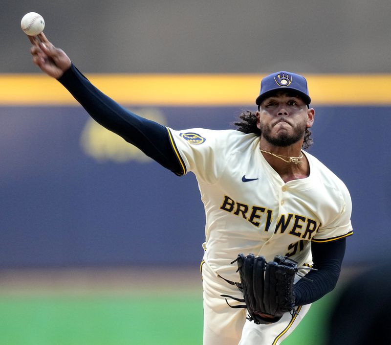 Jun 24, 2024; Milwaukee, Wisconsin, USA; Milwaukee Brewers pitcher Freddy Peralta (51) throws during the first inning of their game against the Texas Rangers at American Family Field. Mandatory Credit: Mark Hoffman/INDIANAPOLIS STAR-USA TODAY Sports