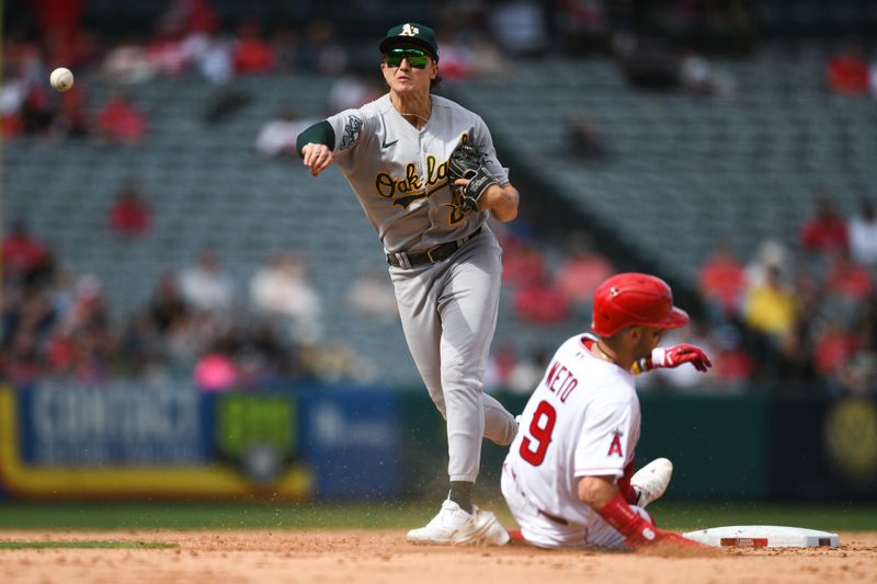 Oct 1, 2023; Anaheim, California, USA; Oakland Athletics second baseman Zack Gelof (20) forces out Los Angeles Angels shortstop Zach Neto (9) and throws to first base for a double play against  first baseman Brandon Drury (23) (not pictured) during the eighth inning at Angel Stadium. Mandatory Credit: Jonathan Hui-USA TODAY Sports