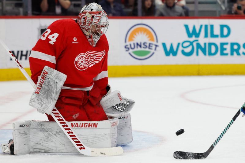 Apr 7, 2024; Detroit, Michigan, USA; Detroit Red Wings goaltender Alex Lyon (34) makes a save in the first period at Little Caesars Arena. Mandatory Credit: Rick Osentoski-USA TODAY Sports