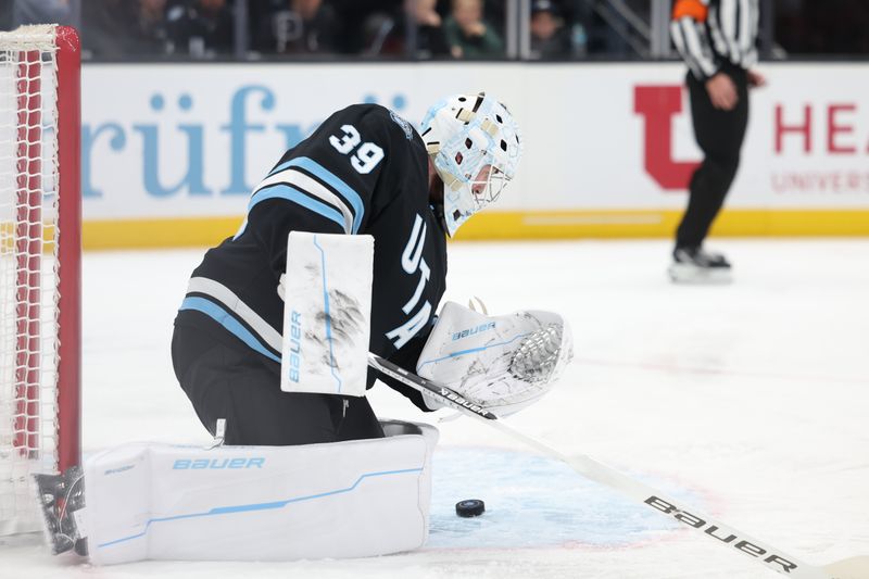 Oct 30, 2024; Salt Lake City, Utah, USA; Utah Hockey Club goaltender Connor Ingram (39) makes a save against the Calgary Flames during the first period at Delta Center. Mandatory Credit: Rob Gray-Imagn Images