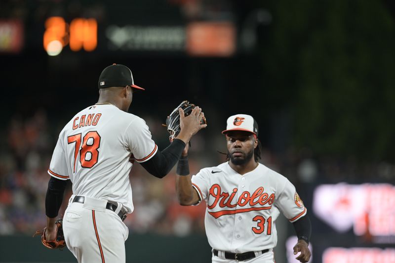 Aug 23, 2023; Baltimore, Maryland, USA;  Baltimore Orioles relief pitcher Yennier Cano (78) high fives center fielder Cedric Mullins (31) after the eighth inning against the Toronto Blue Jays at Oriole Park at Camden Yards. Mandatory Credit: Tommy Gilligan-USA TODAY Sports