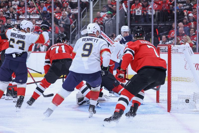 Oct 16, 2025; Newark, New Jersey, USA; Florida Panthers center Evan Rodrigues (17) scores a goal on New Jersey Devils goaltender Jake Allen (34) during the first period at Prudential Center. Mandatory Credit: Ed Mulholland-Imagn Images