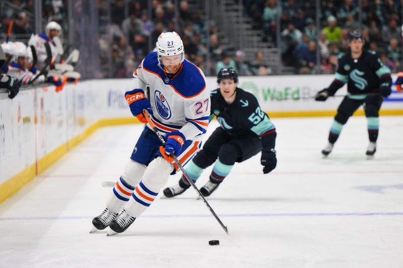 Mar 2, 2024; Seattle, Washington, USA; Edmonton Oilers defenseman Brett Kulak (27) plays the puck against the Seattle Kraken during the second period at Climate Pledge Arena. Mandatory Credit: Steven Bisig-USA TODAY Sports