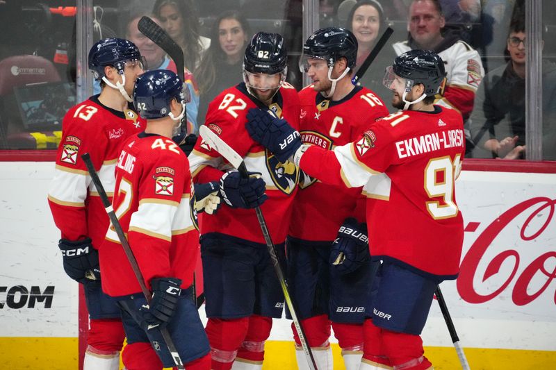 Nov 10, 2023; Sunrise, Florida, USA; Florida Panthers center Kevin Stenlund (82) celebrates with teammates after scoring a goal against the Carolina Hurricanes during the third period at Amerant Bank Arena. Mandatory Credit: Jasen Vinlove-USA TODAY Sports