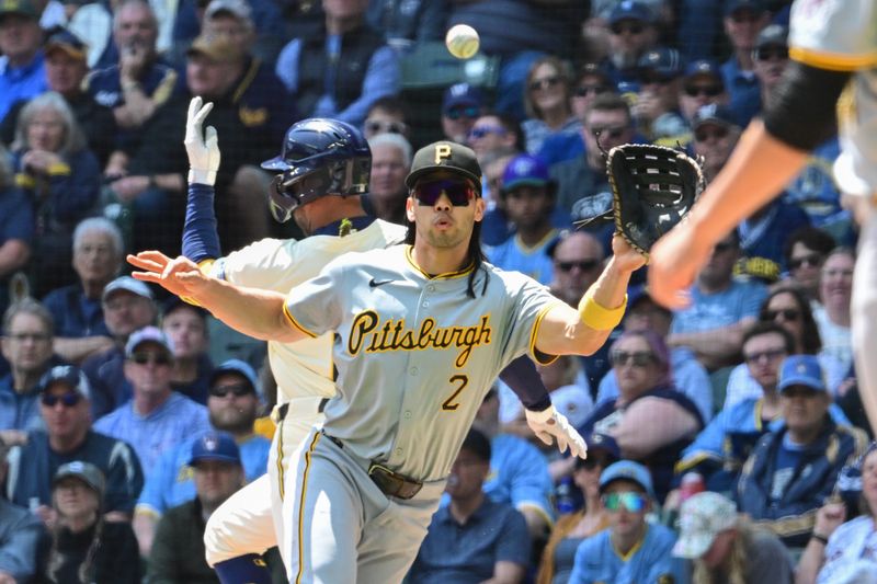 May 15, 2024; Milwaukee, Wisconsin, USA; Pittsburgh Pirates first baseman Connor Joe (2) reaches for the ball on an infield hit by Milwaukee Brewers left fielder Jackson Chourio (11) in the third inning at American Family Field. Mandatory Credit: Benny Sieu-USA TODAY Sports