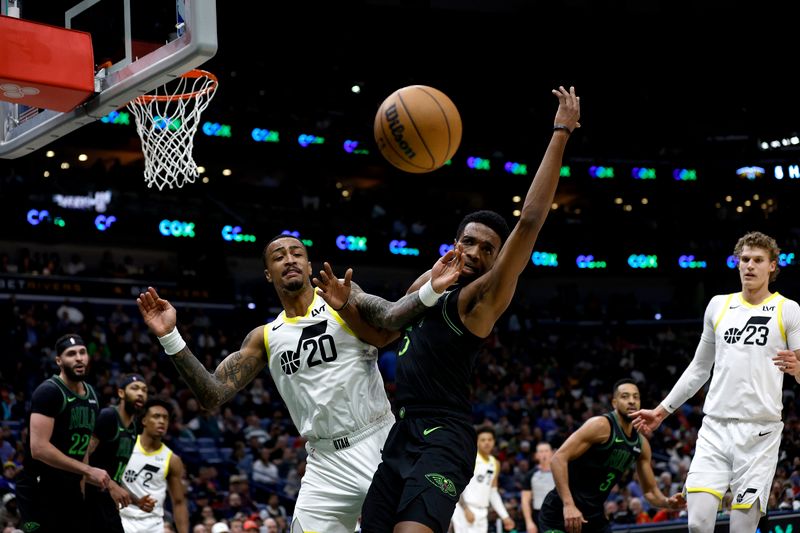 NEW ORLEANS, LOUISIANA - JANUARY 23: John Collins #20 of the Utah Jazz and Herbert Jones #5 of the New Orleans Pelicans scramble for a loos ball during the third quarter an NBA game at Smoothie King Center on January 23, 2024 in New Orleans, Louisiana. NOTE TO USER: User expressly acknowledges and agrees that, by downloading and or using this photograph, User is consenting to the terms and conditions of the Getty Images License Agreement. (Photo by Sean Gardner/Getty Images)