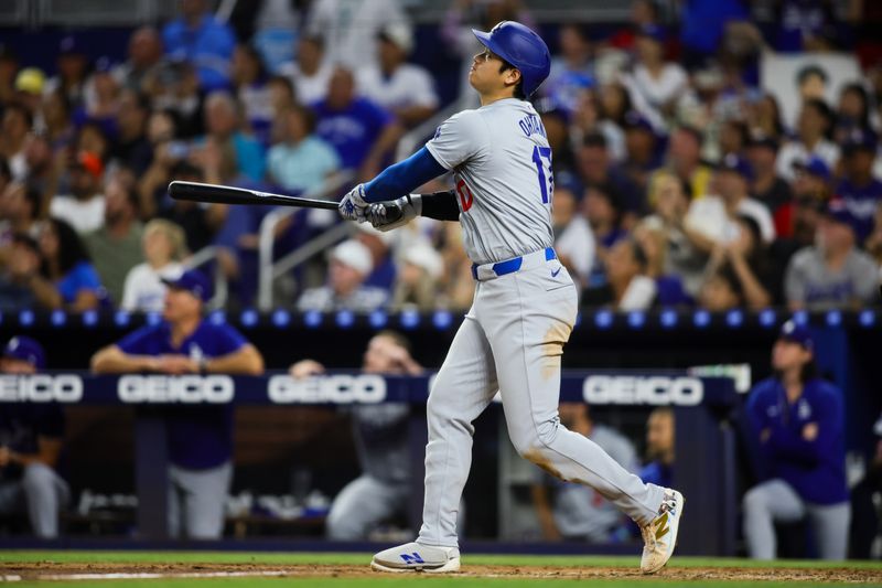 Sep 19, 2024; Miami, Florida, USA; Los Angeles Dodgers designated hitter Shohei Ohtani (17) hits a two-run home run against the Miami Marlins during the sixth inning at loanDepot Park. Mandatory Credit: Sam Navarro-Imagn Images
