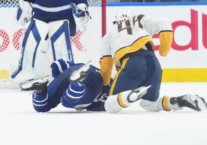 Dec 9, 2023; Toronto, Ontario, CAN; Toronto Maple Leafs defenseman Jake McCabe (22) fights with Nashville Predators left wing Kiefer Sherwood (44) during the third period at Scotiabank Arena. Mandatory Credit: Nick Turchiaro-USA TODAY Sports