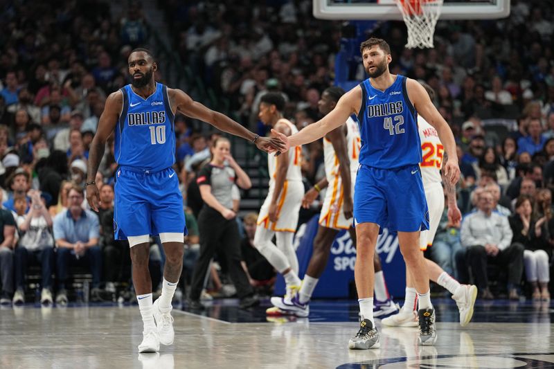 DALLAS, TX - APRIL 4: Tim Hardaway Jr. #10 of the Dallas Mavericks & Maxi Kleber #42 of the Dallas Mavericks high five during the game on April 4, 2024 at the American Airlines Center in Dallas, Texas. NOTE TO USER: User expressly acknowledges and agrees that, by downloading and or using this photograph, User is consenting to the terms and conditions of the Getty Images License Agreement. Mandatory Copyright Notice: Copyright 2024 NBAE (Photo by Glenn James/NBAE via Getty Images)