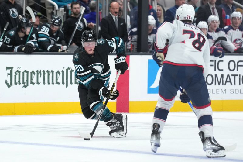 Feb 17, 2024; San Jose, California, USA; San Jose Sharks left wing Fabian Zetterlund (20) skates with the puck against Columbus Blue Jackets defenseman Damon Severson (78) during the second period at SAP Center at San Jose. Mandatory Credit: Darren Yamashita-USA TODAY Sports