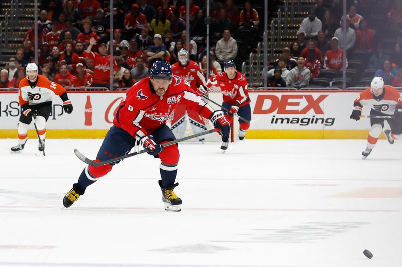 Oct 23, 2024; Washington, District of Columbia, USA; Washington Capitals left wing Alex Ovechkin (8) chases a loose puck en route to scoring an empty net goal against the Philadelphia Flyers in the third period at Capital One Arena. Mandatory Credit: Geoff Burke-Imagn Images