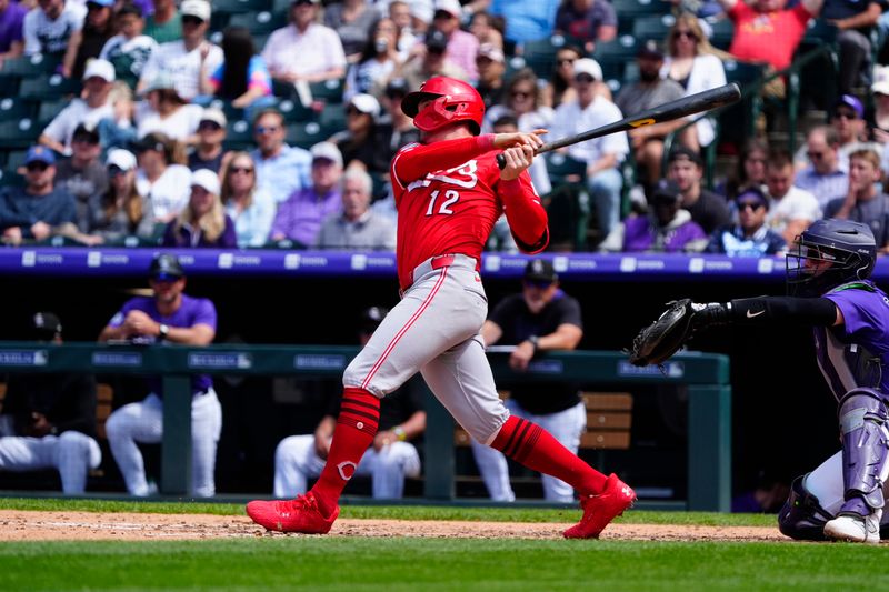 Apr 26, 2025; Denver, Colorado, USA; Cincinnati Reds outfielder Austin Hays (12) hits a solo home run in the sixth inning against the Colorado Rockies at Coors Field. Mandatory Credit: Ron Chenoy-Imagn Images