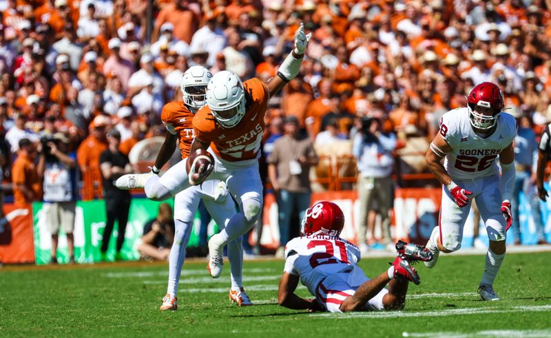 Oct 7, 2023; Dallas, Texas, USA;  Texas Longhorns running back Jonathon Brooks (24) jumps as Oklahoma Sooners defensive back Reggie Pearson (21) tries to make teh tackle during the second half at the Cotton Bowl. Mandatory Credit: Kevin Jairaj-USA TODAY Sports