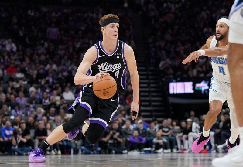 SACRAMENTO, CALIFORNIA - JANUARY 03: Kevin Huerter #9 of the Sacramento Kings dribbling the ball looks to drive towards the basket against the Orlando Magic during the first half of an NBA basketball game at Golden 1 Center on January 03, 2024 in Sacramento, California. NOTE TO USER: User expressly acknowledges and agrees that, by downloading and or using this photograph, User is consenting to the terms and conditions of the Getty Images License Agreement. (Photo by Thearon W. Henderson/Getty Images)