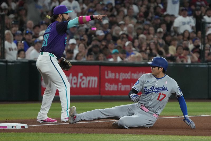 May 11, 2025; Phoenix, Arizona, USA; Los Angeles Dodgers Shohei Ohtani (17) slides into thidbase in front of Arizona Diamondbacks third base Eugenio Suárez (28) in the fifth inning at Chase Field. Mandatory Credit: Rick Scuteri-Imagn Images