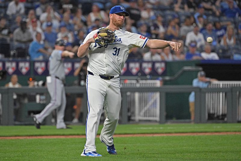 Jun 25, 2024; Kansas City, Missouri, USA;  Kansas City Royals relief pitcher Will Smith (31) throws the ball wide to first base, allowing a run to score for the Miami Marlins in the seventh inning at Kauffman Stadium. Mandatory Credit: Peter Aiken-USA TODAY Sports
