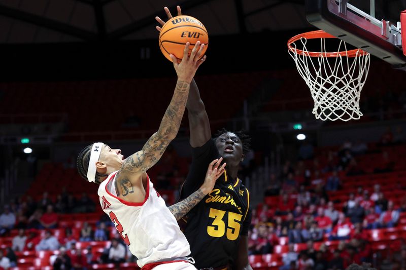 Feb 4, 2026; Salt Lake City, Utah, USA; Utah Utes guard Terrence Brown (2) goes to the basket against Arizona State Sun Devils center Massamba Diop (35) during the second half at Jon M. Huntsman Center. Mandatory Credit: Rob Gray-Imagn Images